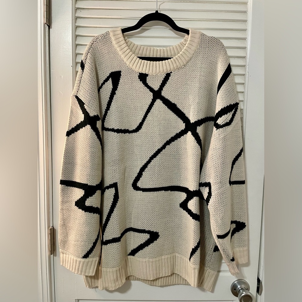 Oversized beige and black long sleeved sweater with design